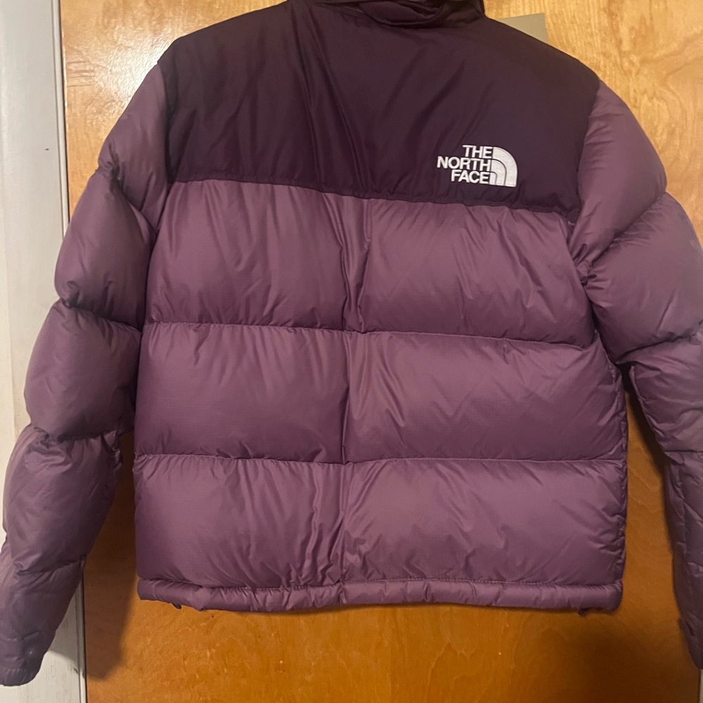 Used women north face . Nortface is a medium women . Purple in color .